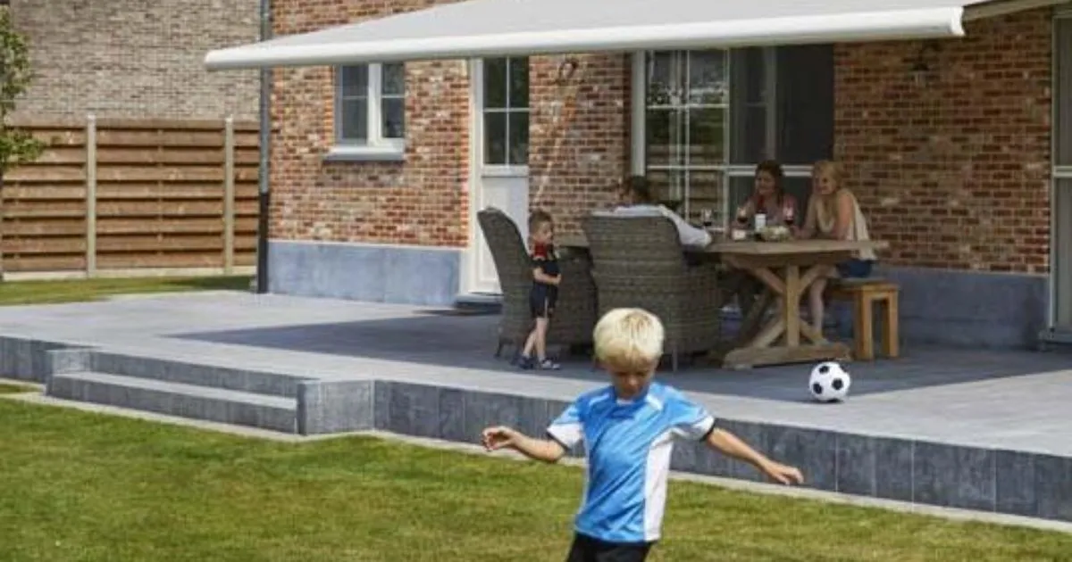 Dubbelarmig knikarmscherm boven een terras in de zon